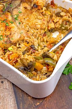 chicken and rice casserole with parsley garnish in a white dish