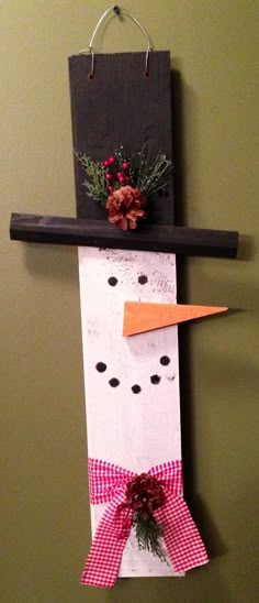 a paper snowman hanging on the wall