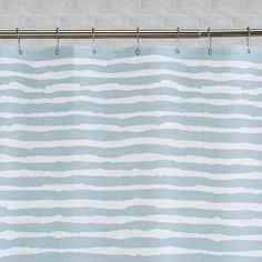 a blue and white shower curtain with wavy lines