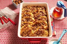 a casserole dish with pecans in it on a red and white checkered tablecloth