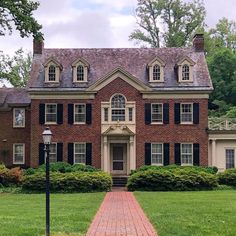 a large brick house with two story windows