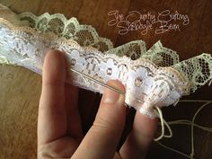 someone is sewing lace on a piece of fabric