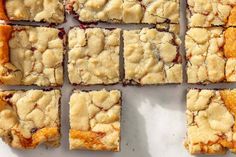 several pieces of dessert sitting on top of a white countertop next to each other