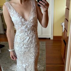 a woman taking a selfie in her wedding dress