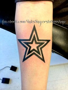 a black and white star tattoo on the leg