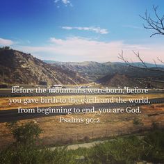 a road with mountains in the background and a bible verse