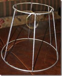 a metal stand with a ring on it sitting on top of a wooden table next to a couch