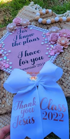 a pink and blue thank you class graduation card on a basket with pearls, beads and flowers