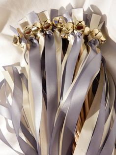 a bunch of ribbons that are on top of each other with gold and silver decorations