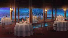 a dining room with tables and chairs overlooking the ocean at night, lit by candles