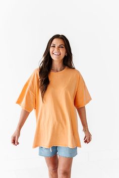 Features Round Neck Short Sleeves Light Orange Color 100% Cotton Size + Fit Small 0-4, Medium 4-8, Large 8-12 Kristin is 5'4", a size 1 and is wearing a Small Oversized fit, size down if you want less oversized. Above recommendation is for an oversized fit. Click here for shorts shown in photos Click here for shorts in Aimee's try on video Orange Oversized Shirt, Light Orange Color, Curvy Swim, Curvy Dress, Boyfriend Tee, Oversized T Shirt, Light Orange, Acid Wash, Bright Orange