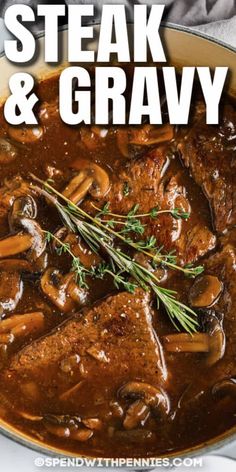 steak and gravy with mushrooms in a skillet on top of a table