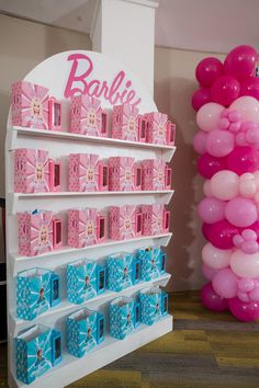 there is a display with pink and blue items on it for barbie fans to view