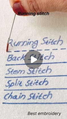 someone is stitching something on a piece of fabric with a needle and thread in their hand