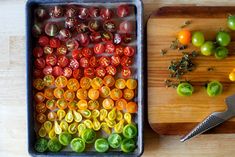 there are tomatoes and other vegetables on the cutting board next to each other, ready to be cut up