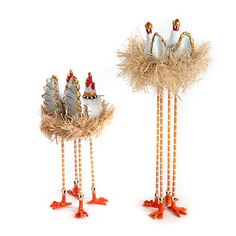 two decorative items made out of feathers and beads on white background, one has an egg in the middle