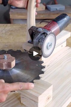 a person using a circular saw to cut wood