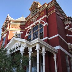 an old red brick building with white columns