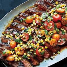 grilled steak with corn and tomatoes on a plate