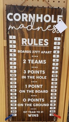 a sign that is on the side of a wooden board with numbers and words written in white