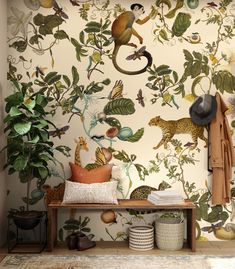 the wallpaper in this room is decorated with tropical animals and plants, including monkeys