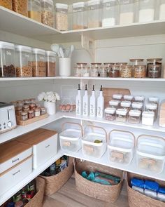 an organized pantry with lots of containers and food items on the shelves in front of it