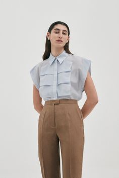 Luxe sleeveless shirt blouse in Cotton | Silk from Australian designer PALMA MARTÎN.  Featuring a confident silhouette with wide shoulders, and front ruffle detail. Blue Silk Blouse, Wide Shoulders, Garment Care Labels, Colour Colour, Blue Fits, White Colour, High End Fashion, Sleeveless Shirt, Ice Blue