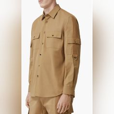 Long Sleeve Cotton Twill Shirt In Tan. Spread Collar. Button Closure At Front. Flap Pockets At Chest And Upper Sleeves. Tonal Webbing Trim Featuring D-Ring Hardware At Shoulders And Sleeves. Single-Button Barrel Cuffs. Shirttail Hem. Logo-Engraved Tortoiseshell Hardware.Supplier Color: Pale Coffee. Cut By The Button, Not Seen If Buttoned Up. Easy Stitch-Up. See Last Picture. Burberry Shirts For Men, Burberry Shirts, Burberry Shirt, Coffee Shirt, Button Up Shirt Mens, Easy Stitch, Gingham Shirt, Button Down Shirt Mens, Twill Shirt