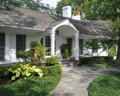 a white house with landscaping around it