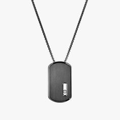 It didn't take long for the Move Titanium collection to become a must-have in men's wardrobes. This time, Valérie Messika has created a military-inspired diamond necklace for men that completes the jewelry collection and adds a rock feel. Available in three colours, this dark grey version is the most technical: it involves a technique used in aeronautics and Formula 1 called DLC (Diamond-Like Carbon) to darken the naturally light grey titanium. This unique look is combined with a brushed metal f White Gold Polished Dog Tag Necklace, Luxury Polished Dog Tag Necklace, Modern Engraved Dog Tag Necklace, Messika Jewelry, Titanium White, Necklace For Men, Military Inspired, Brushed Metal, Diamond Pendant Necklace