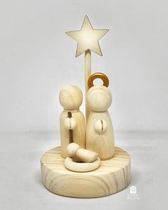 a wooden nativity scene with a star on top