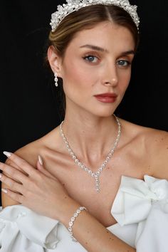 It consists entirely of first class zircon stones. Introducing our exquisite Wedding Jewelry Set, featuring a stunning necklace, ring, and bracelet. Crafted with the finest materials, this set boasts a diamond-like shine that will turn heads wherever you go. Each piece is carefully designed with sparkling, zircon clear stones that mimic the brilliance of real diamonds. The necklace features a delicate chain that gracefully showcases the dazzling centerpiece, while the matching bracelet and ring Elegant Silver Jewelry Sets With Diamond Cut, Brilliant Cut Crystal Jewelry Sets For Anniversary, Anniversary Jewelry Sets With Brilliant Cut Crystals, Elegant White Gold Bridal Sets For Wedding, Brilliant Cut Cubic Zirconia Jewelry Sets For Anniversary, Wedding Bridal Earrings With Diamond-cut Crystal, Fine Jewelry Set With Sparkling Stones For Anniversary, Exquisite White Gold Crystal Jewelry Sets, Exquisite White Gold Cubic Zirconia Jewelry Sets