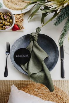 a place setting with plates, napkins and silverware