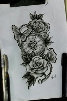 a drawing of a clock with roses and butterflies on the side, next to a pen