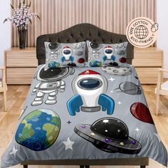 a bed with a space themed comforter and pillows