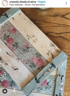 an old wooden box with flowers painted on the side and some paint splatters around it