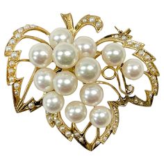 14 Karat Yellow Gold Pearl Cluster Leaf Brooch. This brooch features thirteen 6.5 and 7mm cultured pearls. The pearls are white with pinkish tones and they have good clean luster with only light blemishes. The pearls are set atop a gold leaf outline shape with milgrain detail and seed pearls all around. Stamped on the back of the brooch is K14. The brooch/pin has a gold weight of 11.7 grams. Handmade Yellow Gold Brooches Collectible, Fine Jewelry Yellow Gold Hallmarked Brooches, Antique Yellow Gold Hallmarked Brooches, Hallmarked Yellow Gold Brooches, Fine Jewelry, Vintage Pearl Gold Brooches, Leaf Outline, Pearl Cluster, Seed Pearl, Gold Pearl