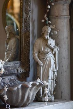 a statue and mirror in a room