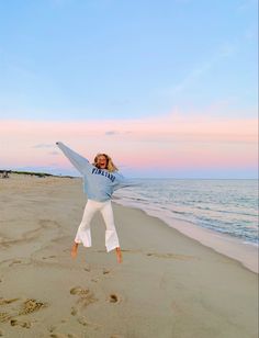 a person jumping in the air on a beach