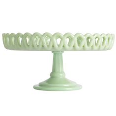 a green cake plate with wavy design on the top and bottom, set against a white background