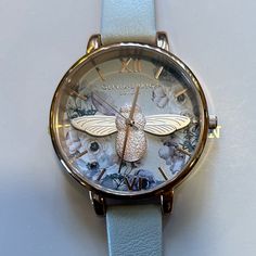 Oliviai Burton Watercolor Florals Watch With 38mm Offwhite Face With Florals & 3d Rosegold 3d Bee & Rosegold Hands & Rosegold Roman Numerals Hour Markers & Rosegold Bezel & Oofwhite Leather Band. Its Original Retail Price Is $225 & Overheads Enjoy The Gorgeous Watch At Great Discount. Olivia Burton, Roman Numerals, Leather Band, Cream White, Floral Watercolor, Accessories Watches, Markers, Bee, Rose Gold