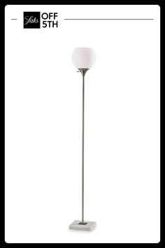 the floor lamp has a white shade on it's base and is next to an off sign