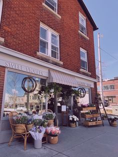 Flower shop. Corner store aesthetic. Flower shop aesthetic. Summer aesthetic. Small town aesthetic. Small town insta photos. Day in the city. Summer in the city. Flowers at corner store. Flowers. Summer photo inspo. Small Town Aesthetic Romance, Small Town Hotel Aesthetic, Small Town Square Aesthetic, Small Town Shops Ideas, Small Town Main Street Aesthetic, Summer In A Small Town Aesthetic, Spring Town Aesthetic, 2000s Small Town Aesthetic, Small Town Home Aesthetic