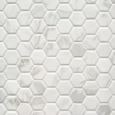 white marble hexagon tiles with grey veining on the backsplashes