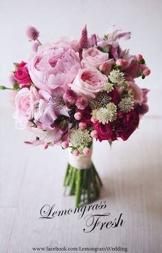 a bouquet of pink and white flowers on a table