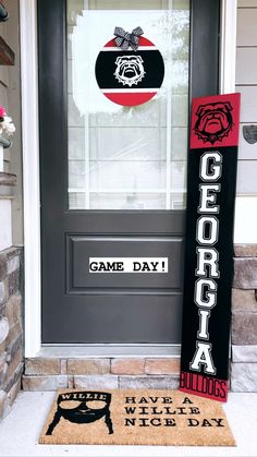 the front door is decorated with black and red decorations, including a sign that says game day