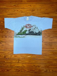 Vintage Cumbres & Toltec Scenic Railroad Shirt > Excellent vintage condition > Imperfections:  small spot on lower front (pictured) > Imperfections:  very light color difference across bottom (pictured) > Classic 90's Cumbres & Toltec tee > Solid color with large wraparound graphic > Great graphic with good color and little to no wear > 50/50 blend > Single stitch sleeve ends and bottom hem   > Tag size is adult Large - L (measurements below) > Measures slightly smaller than tag size (measuremen Vintage Multicolor Graphic Print Camp Shirt, Vintage Blue Camp Shirt With Graphic Print, Chama New Mexico, Vintage Relaxed Fit T-shirt For Rodeo, 90s Era, Scenic Railroads, Modern Outfits, New Mexico, Rocky Mountains