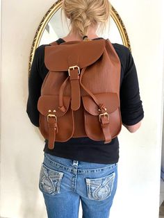 "Backpack bag, brown faux leather backpack,Converts to shoulder bag, mint condition, Whiskey brown Top loop handle for carrying Flap over and Snap clasp closure. 2 front snap close pockets PLEASE SEE MEASUREMENTS Measures: 12\" tall x 10\" x 5.5\" deep Straps: adjustable Should strap drop is 12\" NK216B3 Backpack bag, brown faux leather backpack,Converts to shoulder bag, mint condition, Whiskey brown" Large Capacity Brown Satchel For Students, Brown Large Capacity Satchel For Students, Trendy Brown Leather Backpack For Travel, Brown Softback School Bag, Brown Student Backpack With Softback, Trendy Brown Leather Backpack For School, Brown Student Backpack Softback, Brown Faux Leather School Bag, Casual Brown Leather Backpack For Students