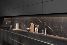 a bathroom with marble counter tops and gold faucets on the wall above it