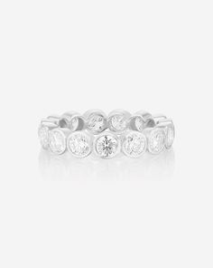 A modern update to the classic eternity band. Dazzling Round Platinum Eternity Band, Luxury Cubic Zirconia Diamond Ring With Bezel Setting, Timeless Platinum Round Eternity Band, Timeless Round Platinum Eternity Band, Luxury Eternity Band With Bezel Setting, Timeless Round Eternity Band With Brilliant Cut, Timeless Cubic Zirconia Diamond Ring With Bezel Setting, Timeless Brilliant Cut Round Eternity Band, Timeless Round Brilliant Cut Eternity Band